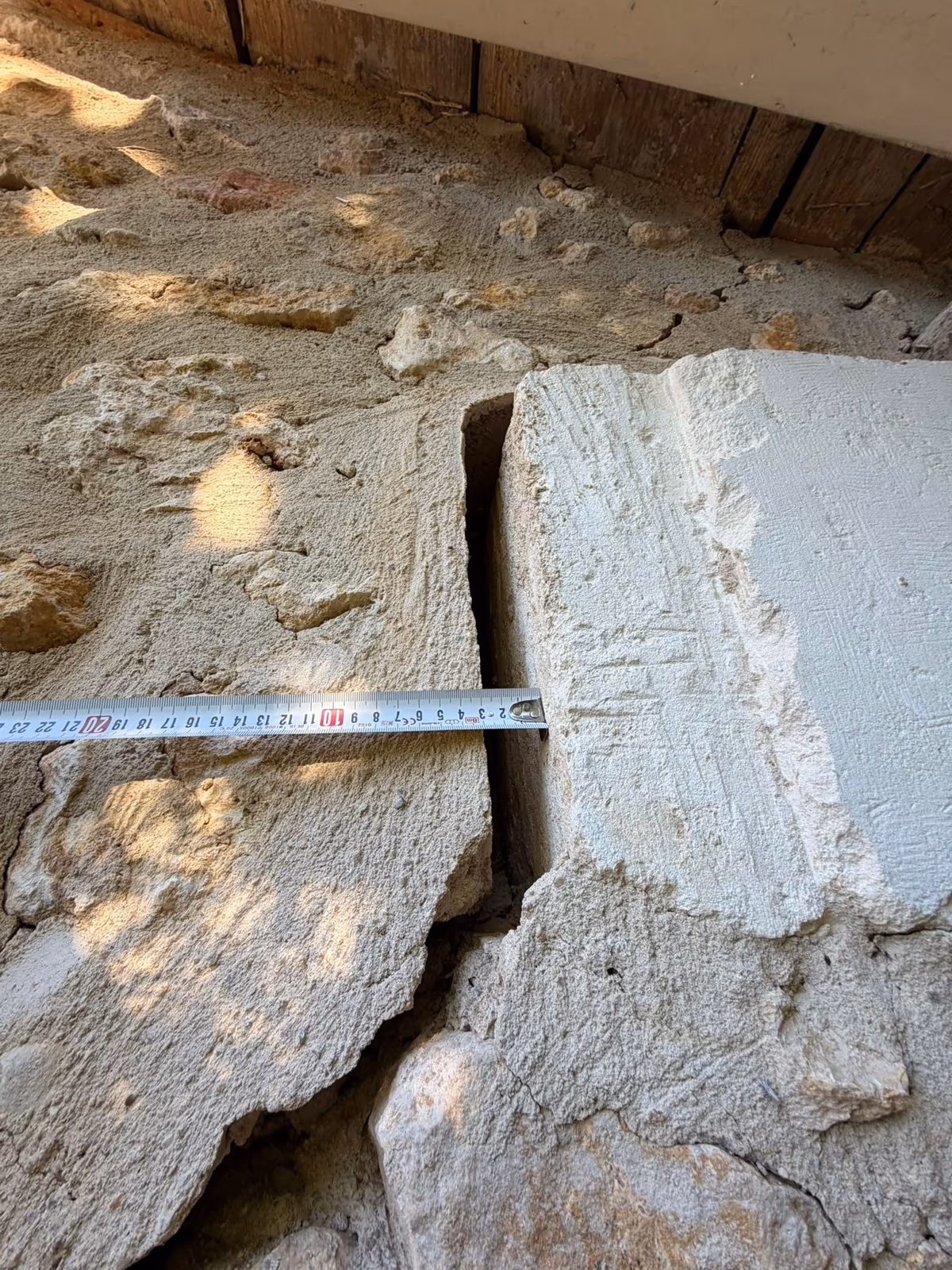 Tape measure across an open crack in a dressed stone